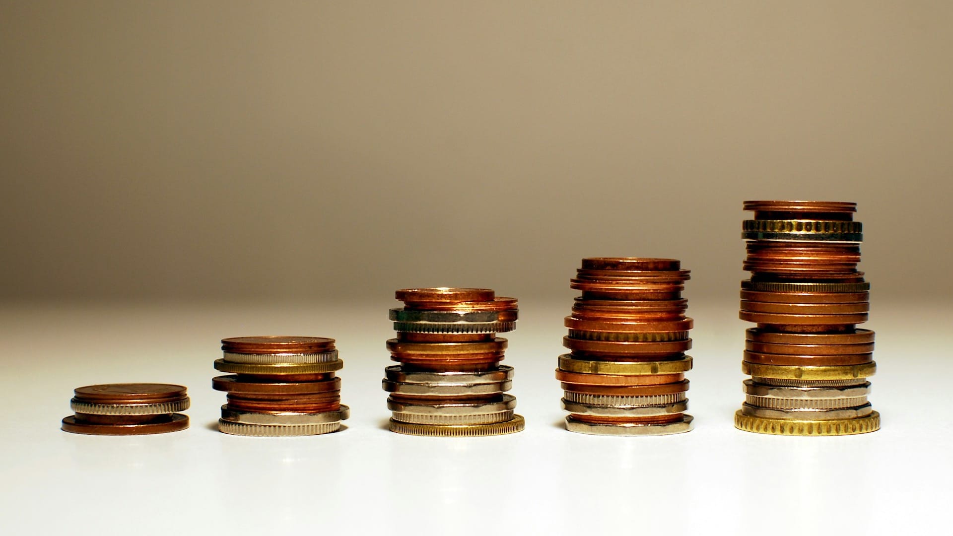 Five stacks of coins increasing in height from left to right