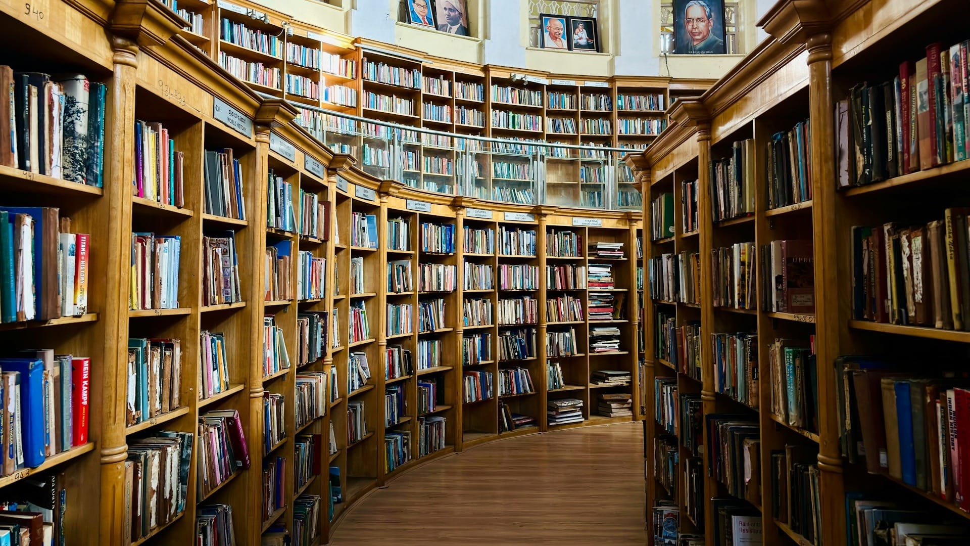 Rows of tall library shelves densely filled with books